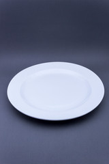 Mock up empty low white plate on grey background.