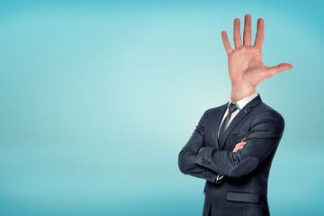 A businessman with folded arms has a large wide opened hand and fingers sticking out.