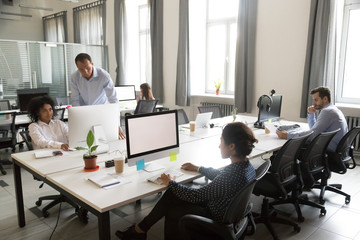 Diverse multi-ethnic workers work together in shared modern office space, multiracial creative...