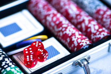 Poker set: plastic playing cards and poker chips in the metal case. Social advertisement, gaming addiction, gambling business, earning methods, entertainment and lifestyle concept. 