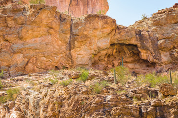 Arizona desert is diverse red slick rock cliffs surround Canyon Lake in the wilderness east of Phoenix with desert plants adding to the beauty of these landscape photographs