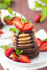 Homemade pancakes with chocolate topping and strawberries 