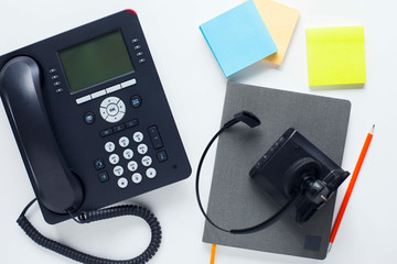 Deskphone, office and business concept. New ip phone with buttons and big display for communication without interference. Top view. Space for a text. Close up.
