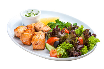 Fototapeta premium Shish kebab from salmon with vegetables and salad. On a white plate