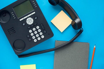 Deskphone, office and business concept. New ip phone with buttons and big display for communication without interference. Top view. Space for a text. Close up.