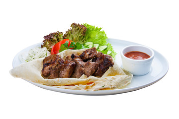 Beef shish kebab in pita bread. On a white plate