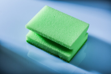 Green sponge on white surface