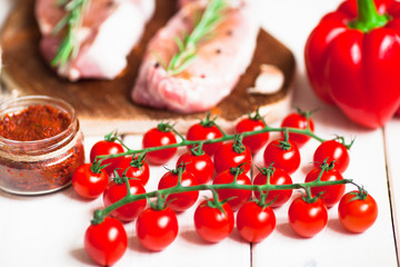 Fresh raw pork on the cutting board with ingredients for cooking. Food, flat lay, recipes and nutrition concept. Top view. Close up.