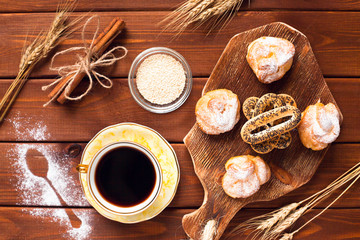 Beautiful set of bakery products and vintage cup of tea. Flat lay composition of breakfast food on the wooden background. Food, break, cooking, lifestyle concept. Top view. Close up.