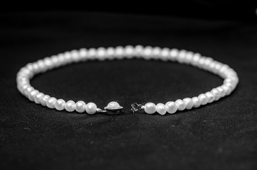pearl necklace on black background