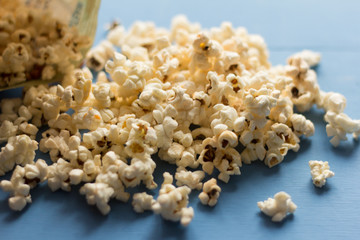 a bunch of popcorn on a blue background, selective focus