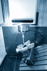 The 5-axis CNC milling machine cutting aluminium  automotive part.The Hi-Technology manufacturing process.
