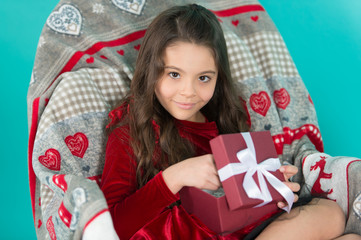 From Santa. Cute little child girl with new year present. Happy little smiling girl open new year gift box. Festive celebration of the New Year Eve at home. Merry Christmas and Happy New Year