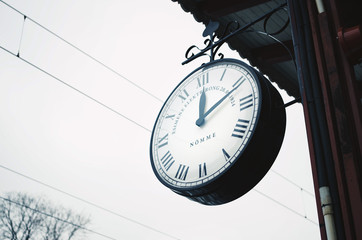 Low angle close-up of an old vintage clock in a railway station.
