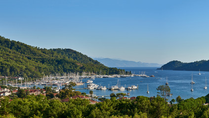 Fototapeta na wymiar Panoramic view of bay and city of Gocek - Fethiye, Turkey with marina and yachts.