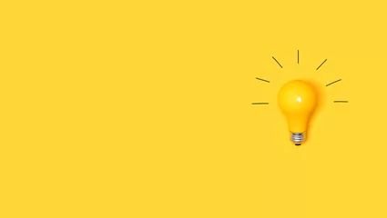 Foto op Plexiglas Idea light bulb on a vivid yellow background © Tierney