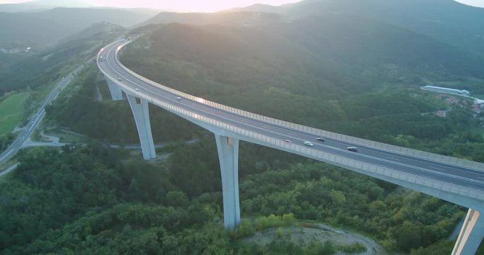 4k aerial footage of traffic over viaduct at sunset