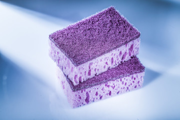 Obraz na płótnie Canvas New violet cleaning sponges on white surface