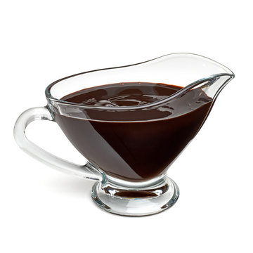 Chocolate sauce in gravy boat isolated on white background with clipping path