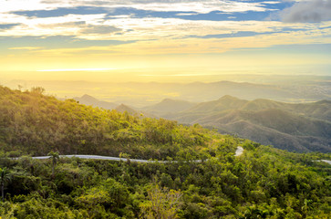 idyllic landscape of the Cuban province at sunset, roads on the hillsides leading to the coast