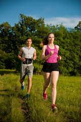 Active young couple running in the park