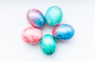 Fototapeta na wymiar Flat lay of colourful bright easter eggs on a white background.