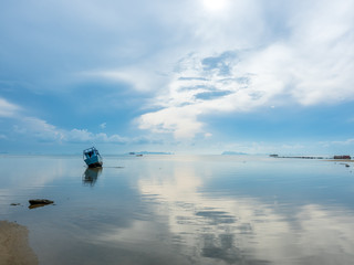 Fisherman boat aground over shallow water