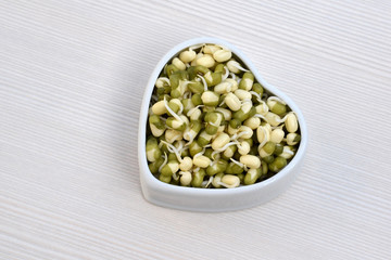 Sprouted mung beans in ceramic bowl of heart shape