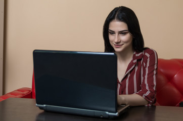 Teenager girl looking on something funny in laptop