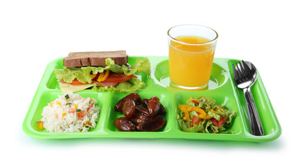 Serving tray with healthy food on white background. School lunch