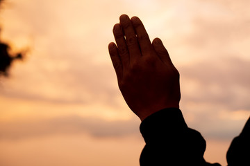 Plakat Man praying and free bird enjoying nature on sunset, Human raising hands. Worship christian Religion. silhouette.
