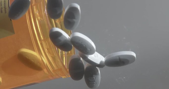 Pain Pills Dropping On Glass Background - Hydrocodone