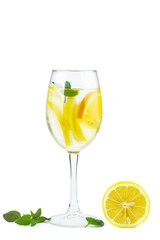 Wineglass with water (or alcohol), lemon slices and mint