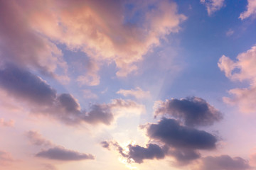 Obraz premium sunset / sun rise sky with rays of yellow and red light shining clouds and sky background and texture