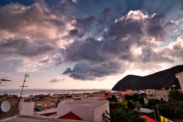 View over Canneto, Lipari, Aeolian Islands as the sun disappears behind a range of hills
