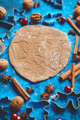 Christmas baking concept. Gingerbread dough with different cutter shapes and spices on sides. Top...