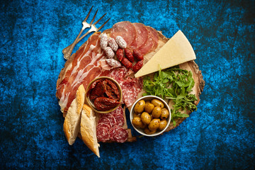 Delicious mix of different snacks and appetizers. Spanish tapas or italian antipasti on a wooden...