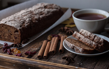 Homemade banana bread with anis star and cinnamon on a dark wooden background