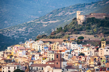 Fototapeta na wymiar The beautiful village of Bosa with colored houses and a medieval castle on the top of the hill. Bosa is located in the north-west of Sardinia, Italy.