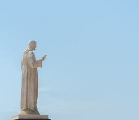 white statue of Jesus on the hill, place of prayers outside