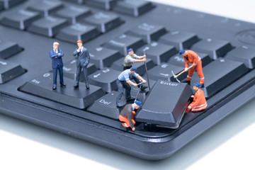 Miniature people repair Computer Keyboard