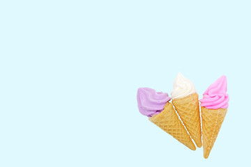 Meringues in mini cone isolated on blue pastel background, clipping path.