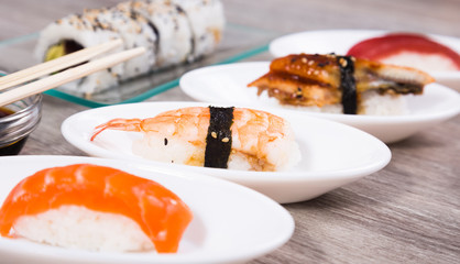 Nigirisushi on oval saucers and Uramaki
