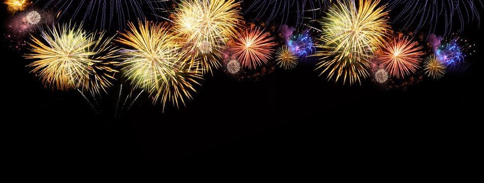 Fireworks colorful explosions on black, festive extra wide background with copy space
