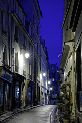 Paris, France - November 1, 2018: View of a street at blue hour after rain in Paris