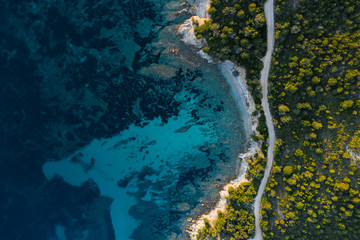 Aerial view of an amazing rocky and green coast bathed by a transparent and turquoise sea. Sardinia, Italy..