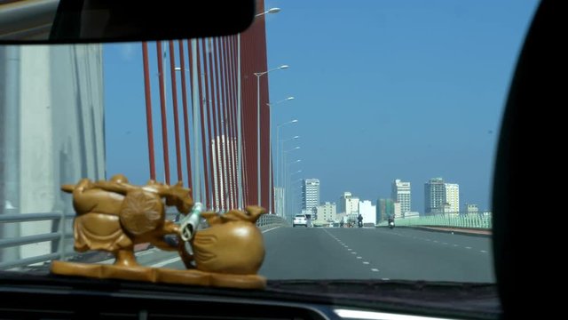 Driving across a cable-stayed bridge toward the city skyline in Danang