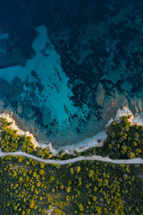 Aerial view of an amazing rocky and green coast bathed by a transparent and turquoise sea. Sardinia, Italy..