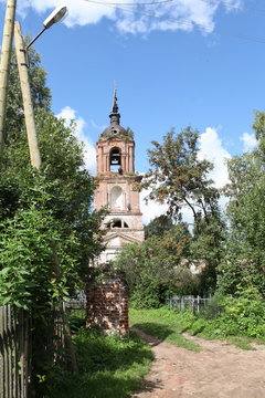 Old bell tower in an abandoned cemetery, teenagers climbed high on the bell tower