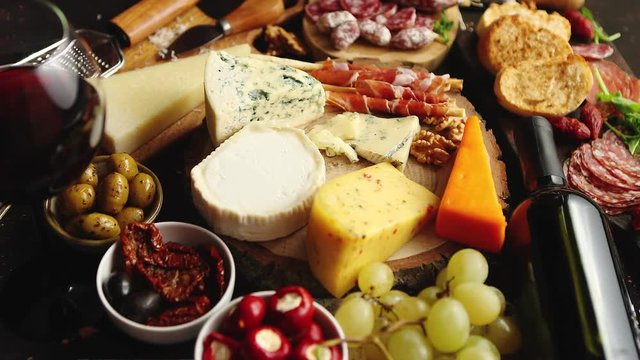 Huge assortment of various tasety spanish, french or italian apertizers. Cheese, meat, olives, stuffed peppers, bread, sticks. Placed on rusty dark background. View from above.